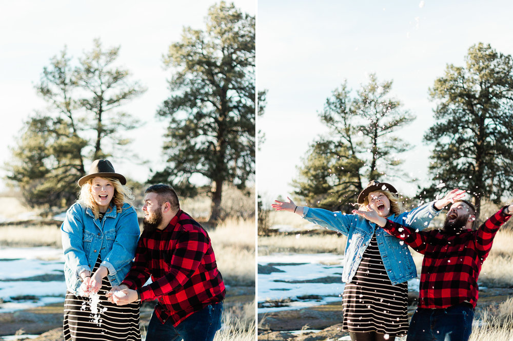 engaged couple throwing snow in castle rock colorado
