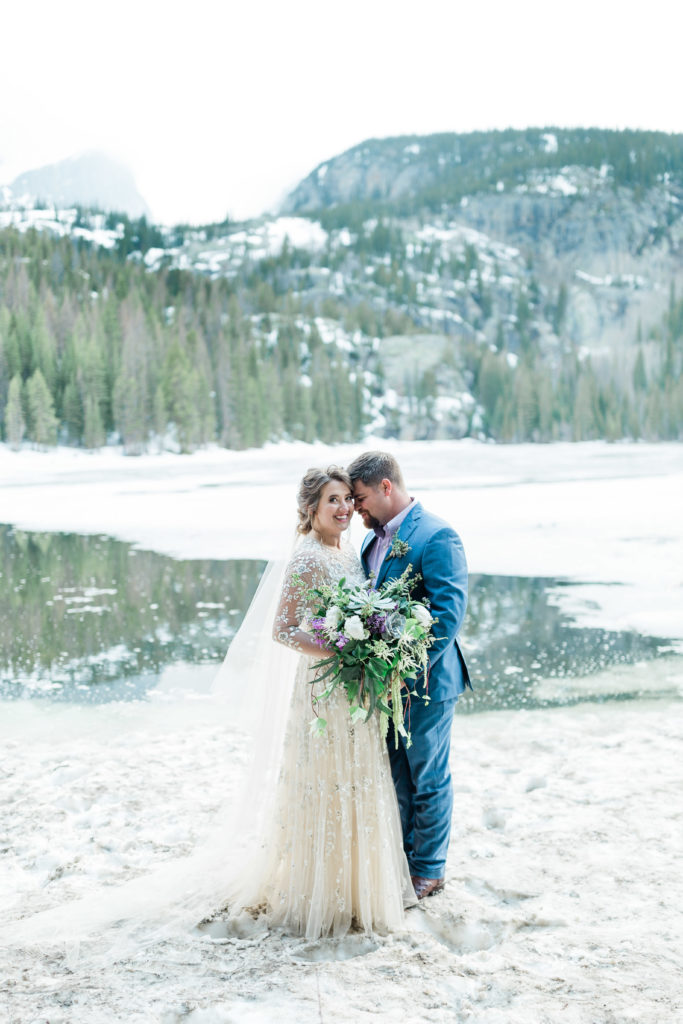 Bride and groom smiling at Bear Lake in Rocky Mountain National Park