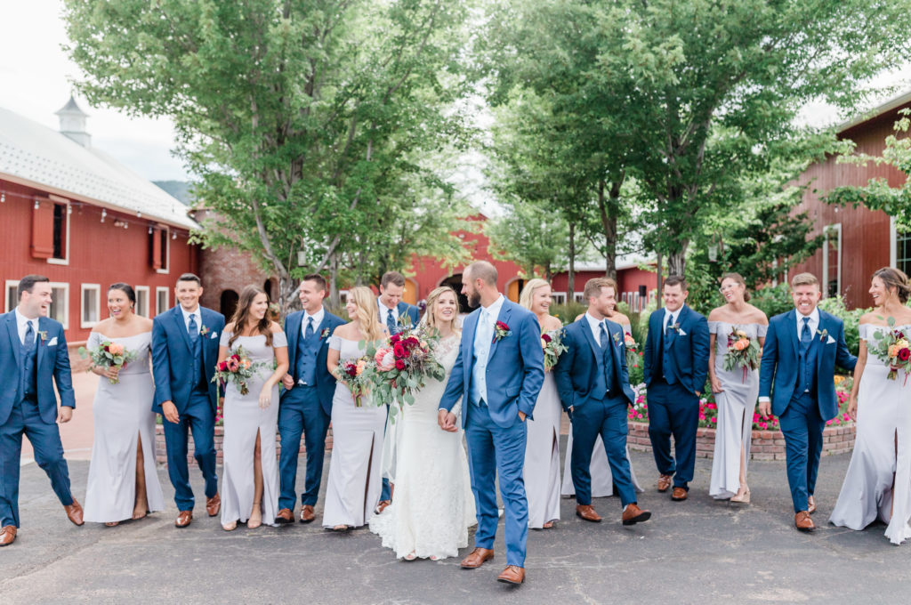 bridal party laughing in courtyard of crooked willow farms
