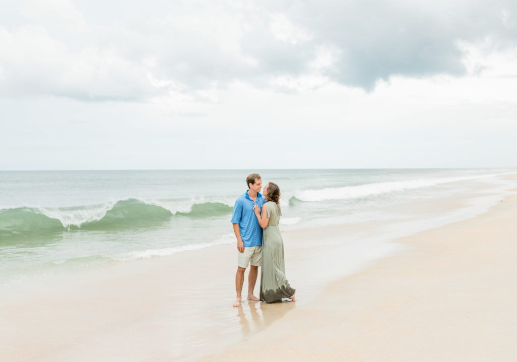 Couple hugging during Hammock Beach engagement session