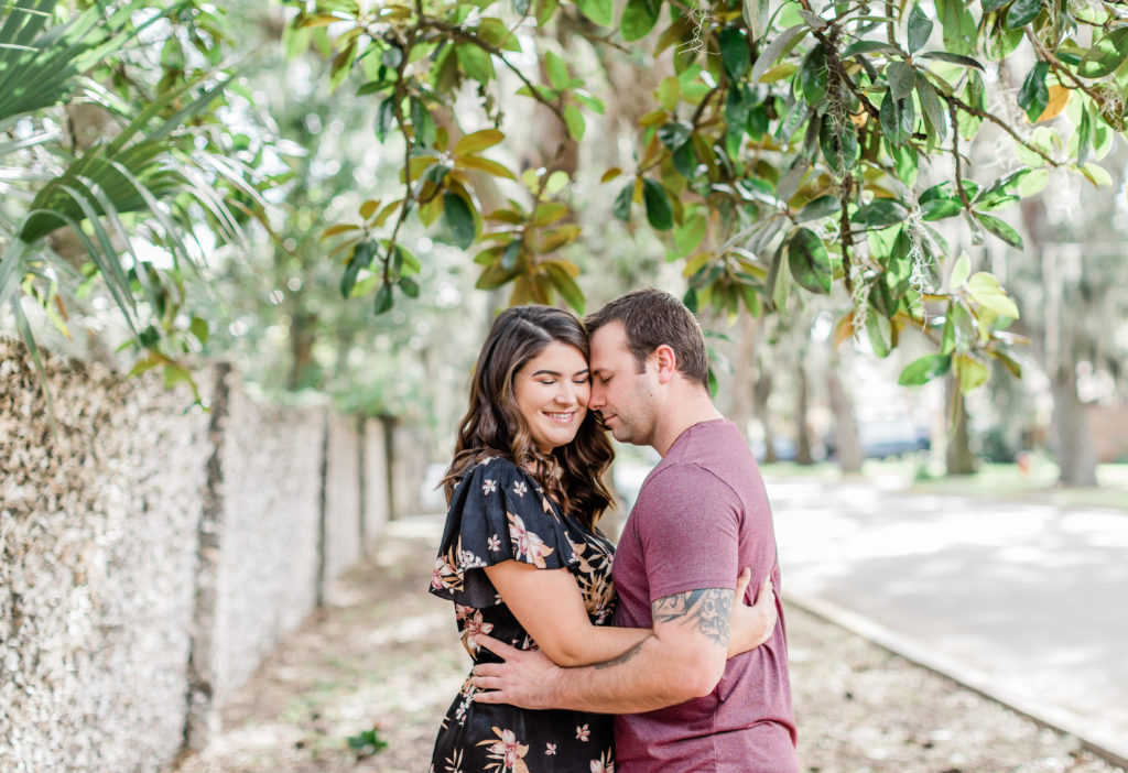 Couple hugging under magnolia tree