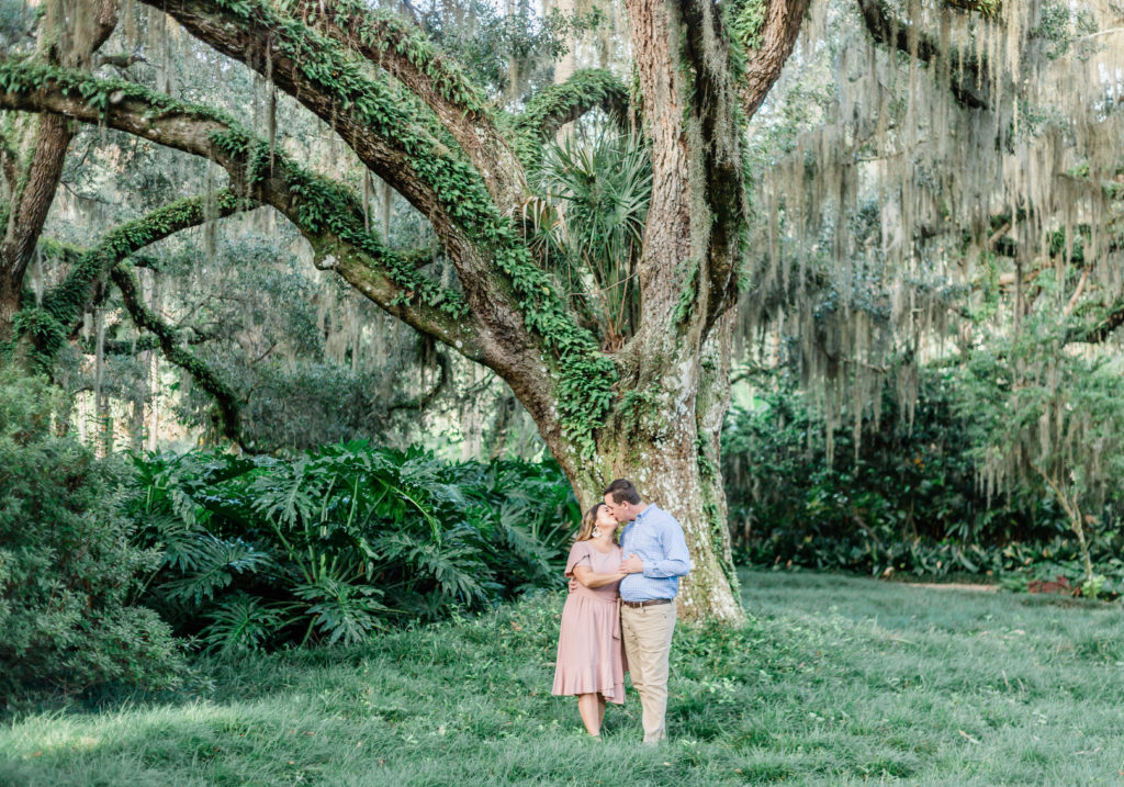 Couple kissing under oak tree