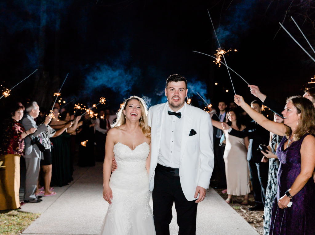 bride and groom smiling during sparkler exit
