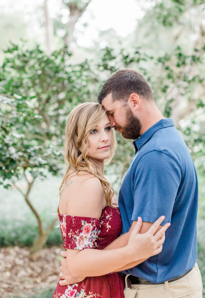 Groom holding bride during engagement session in Palm Coast