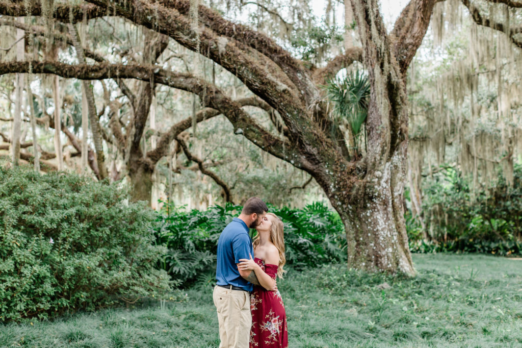 bride and groom kissing under oak tree in Washington Oaks Gardens