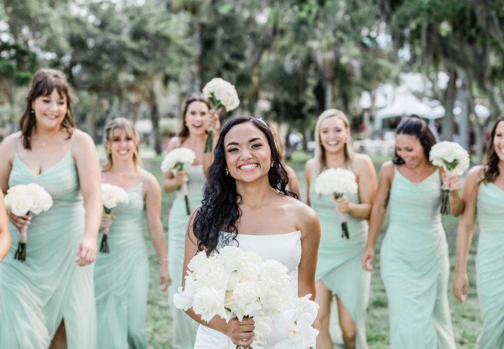 Bride smiling with bridesmaids 