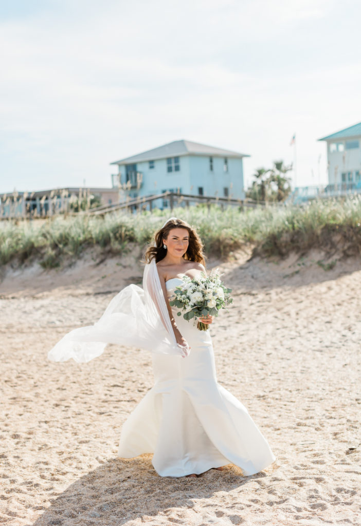 Bride with her veil during beach elopement.