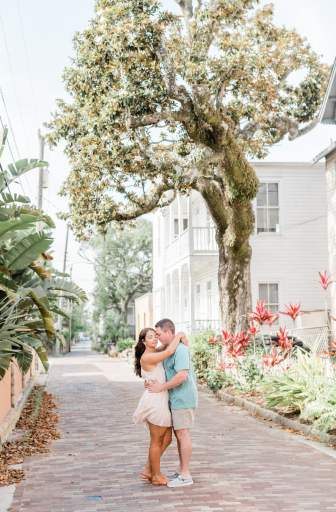 Couple on cobblestone street in St. Augustine during engagement session. 